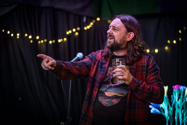 Actor, Writer and Comedian Lou Chawner performing Stand Up Comedy while bantering with the audience