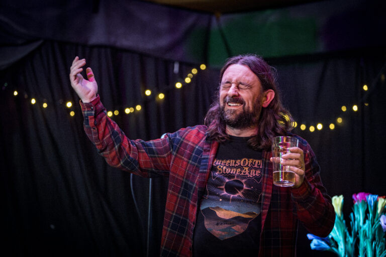 Actor, Writer and Comedian Lou Chawner performing Stand Up Comedy while being surprised by an audience member