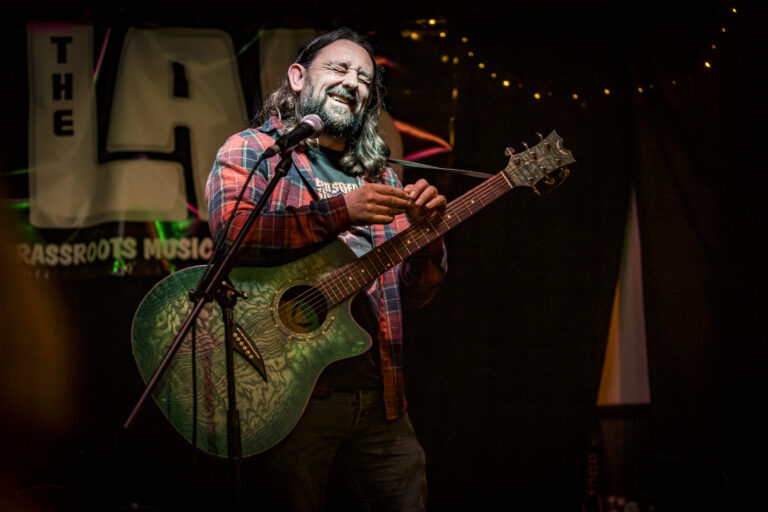 Actor, Writer and Comedian Lou Chawner perfoming Laughing after finishing a song